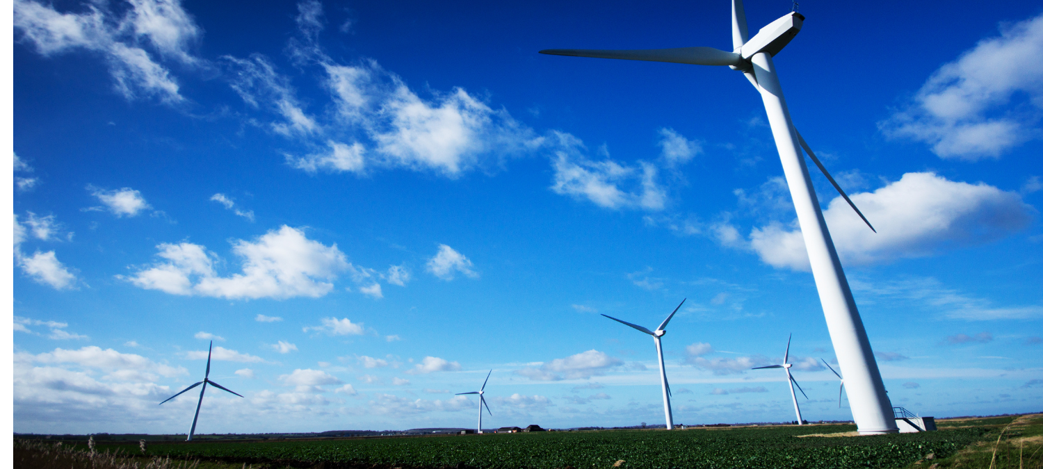 wind turbines in front of a blue sky