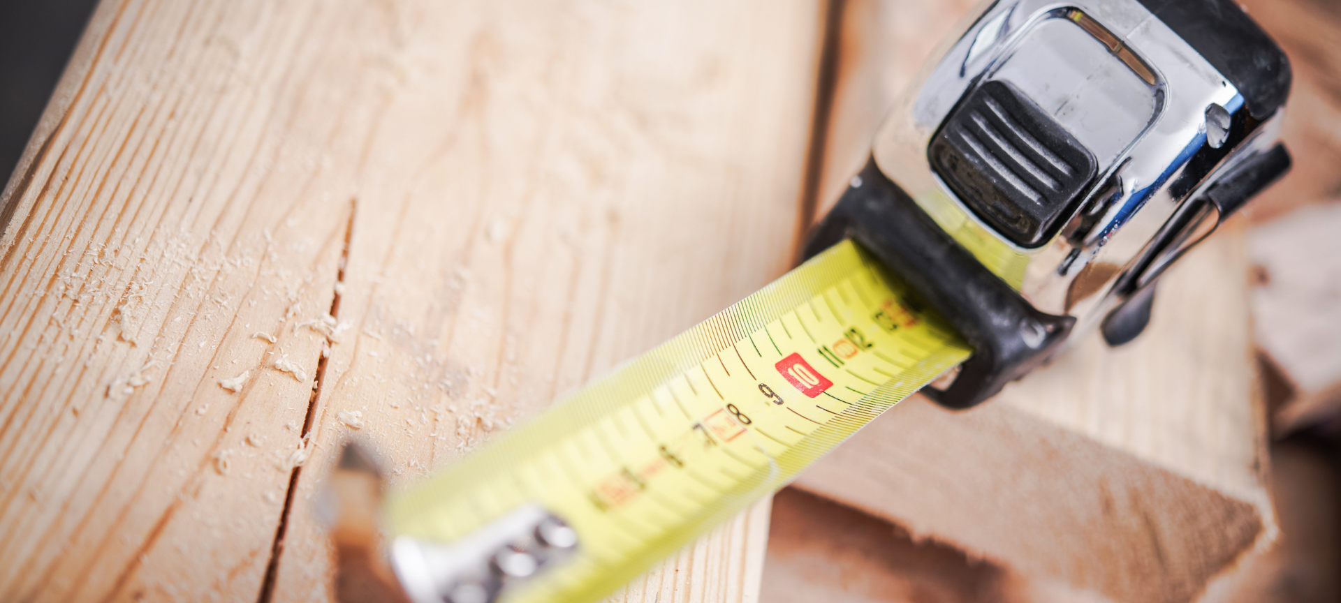 measuring tape standing on a piece of wood
