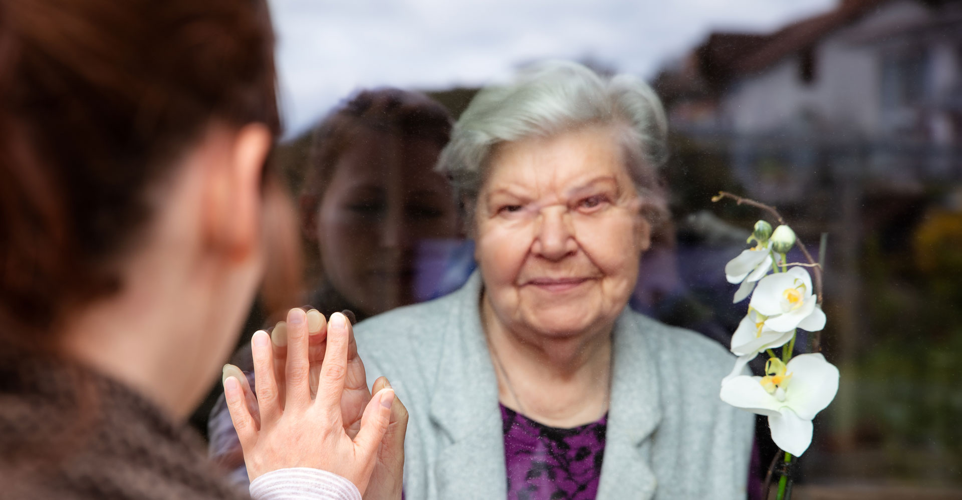 woman and daughter at window