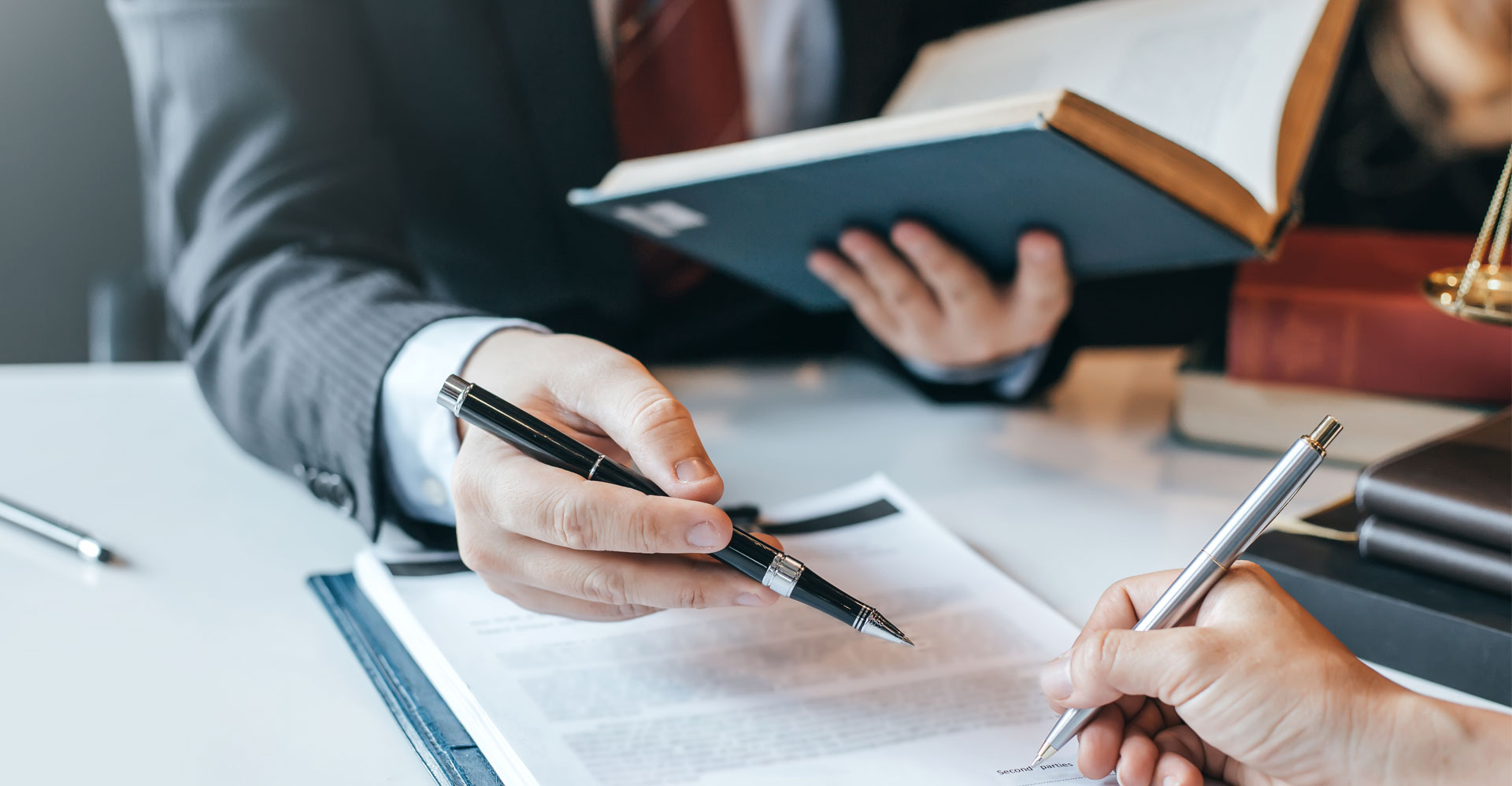 men signing a document