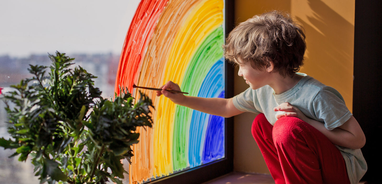 boy painting a rainbow