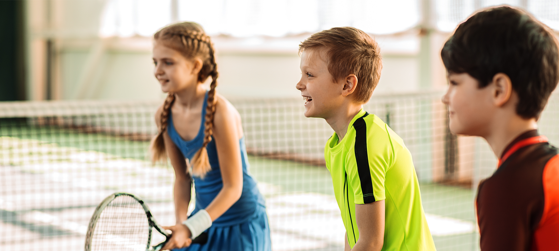 Children in a tennis lesson
