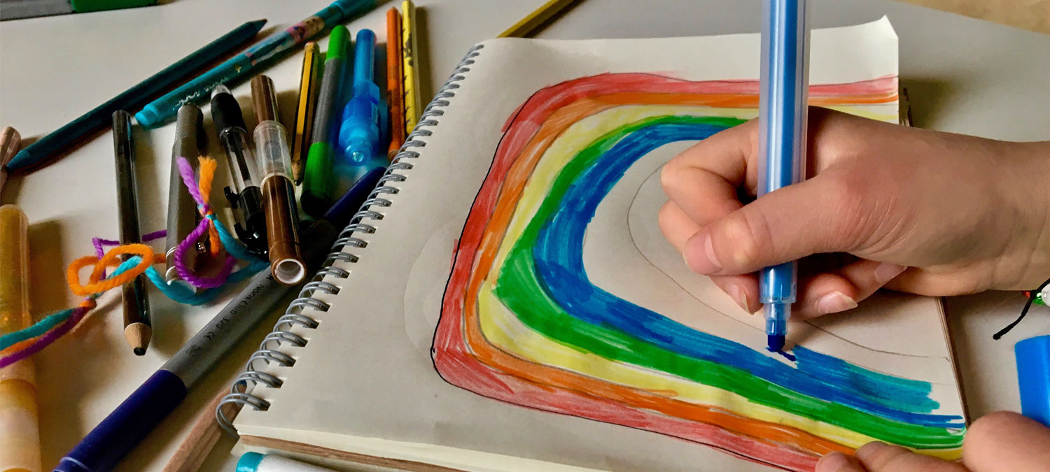 child drawing a rainbow