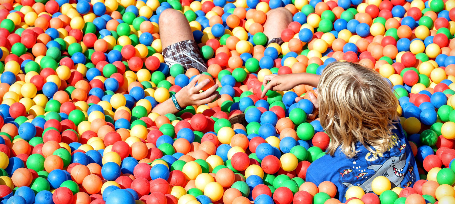 child playing in a ball pit