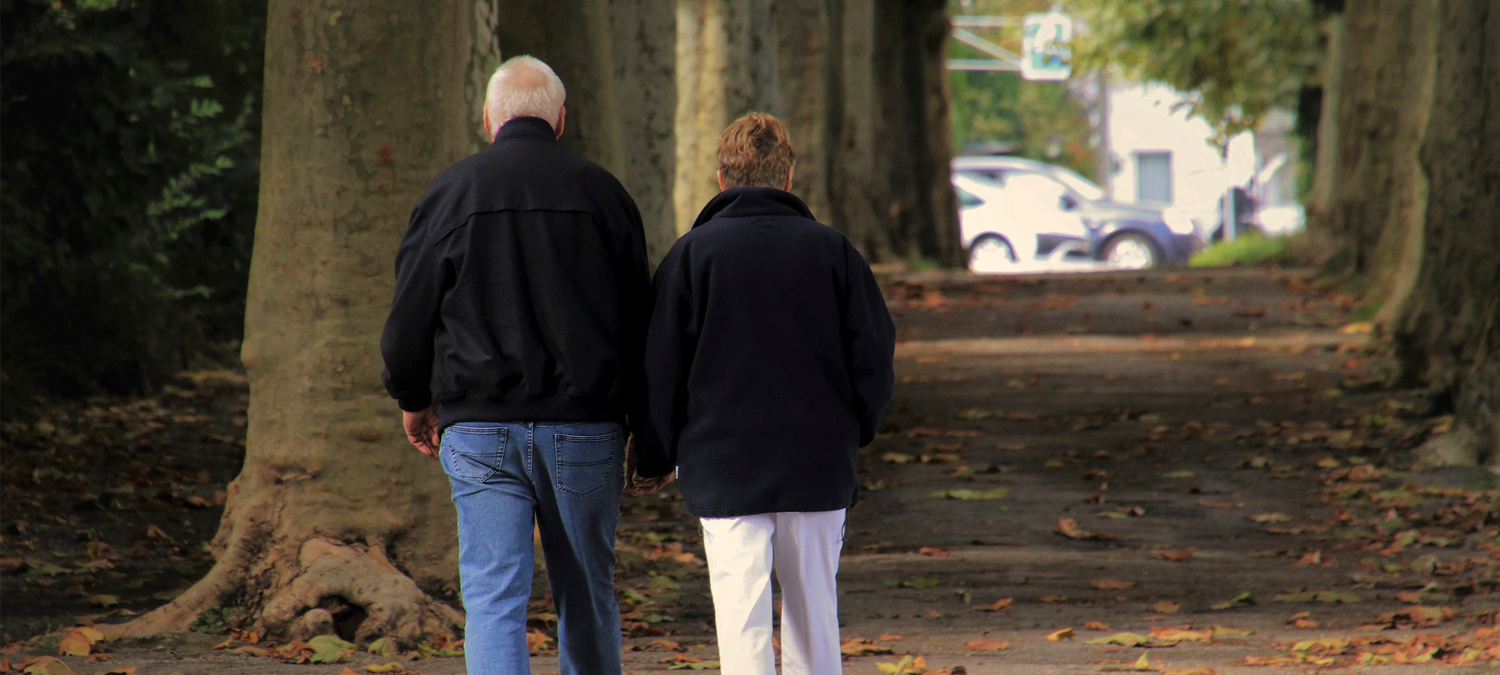 Elderly couple walking outside