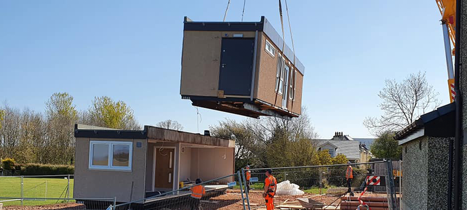 portacabin shop being lowered by a crane