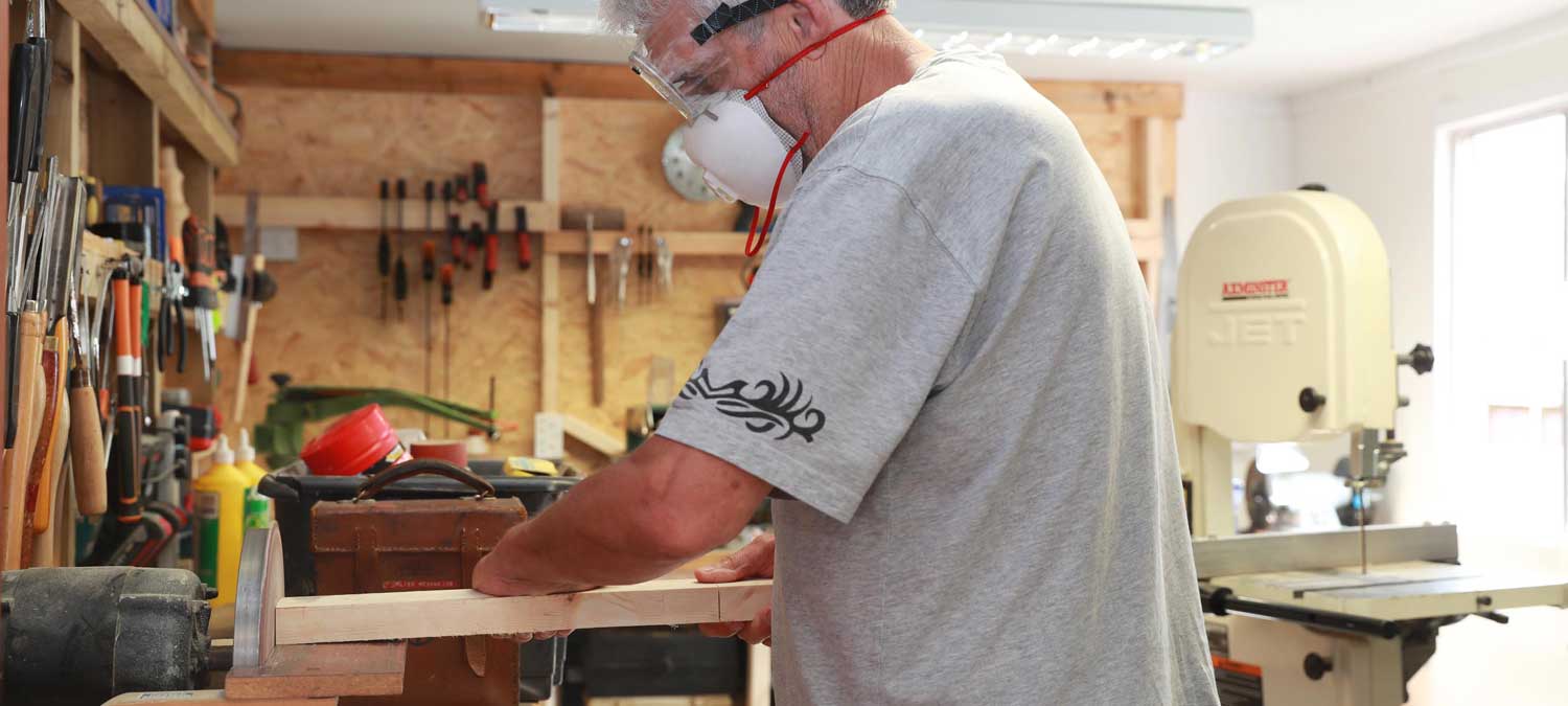 man using power tools in the shed