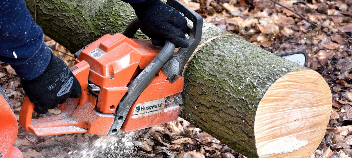 someone cutting wood with a chainsaw