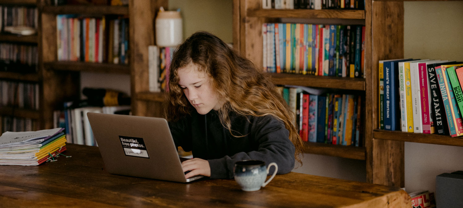 a girl studying online in a library