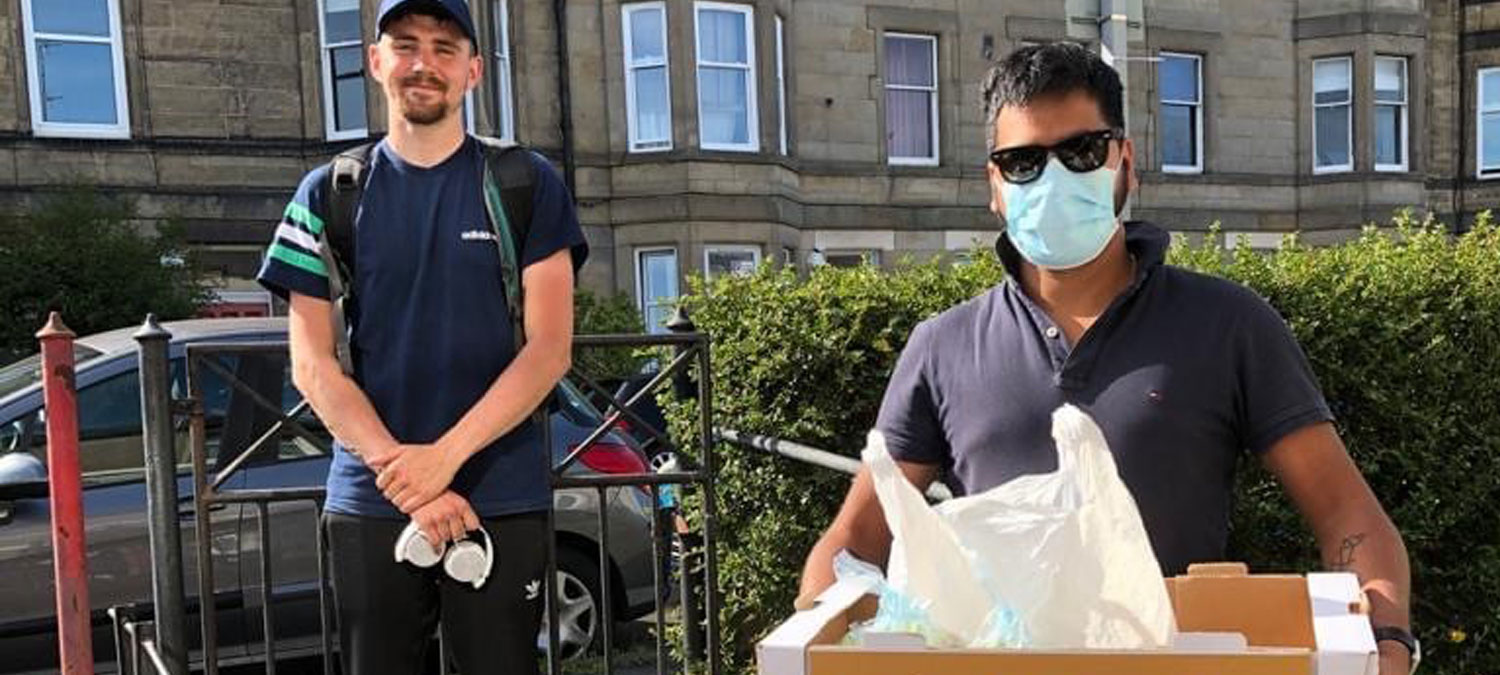 Photo of Building Bridges team delivering food parcels thanks to the RRR Fund