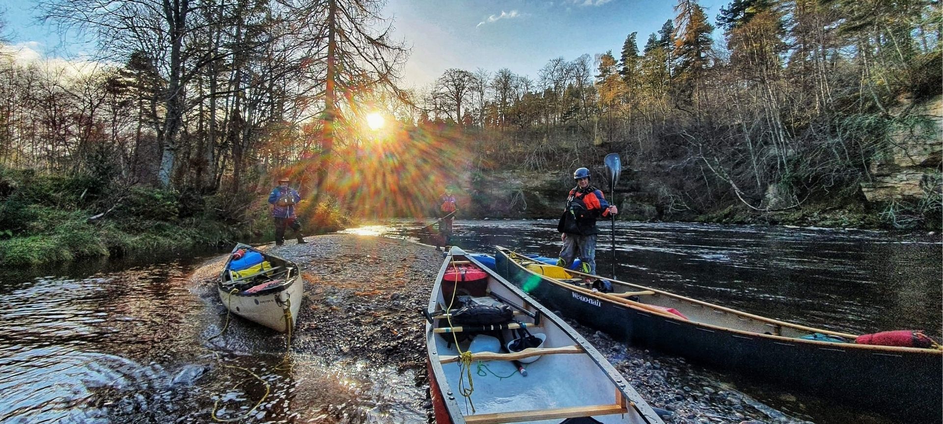 Three canoes on river