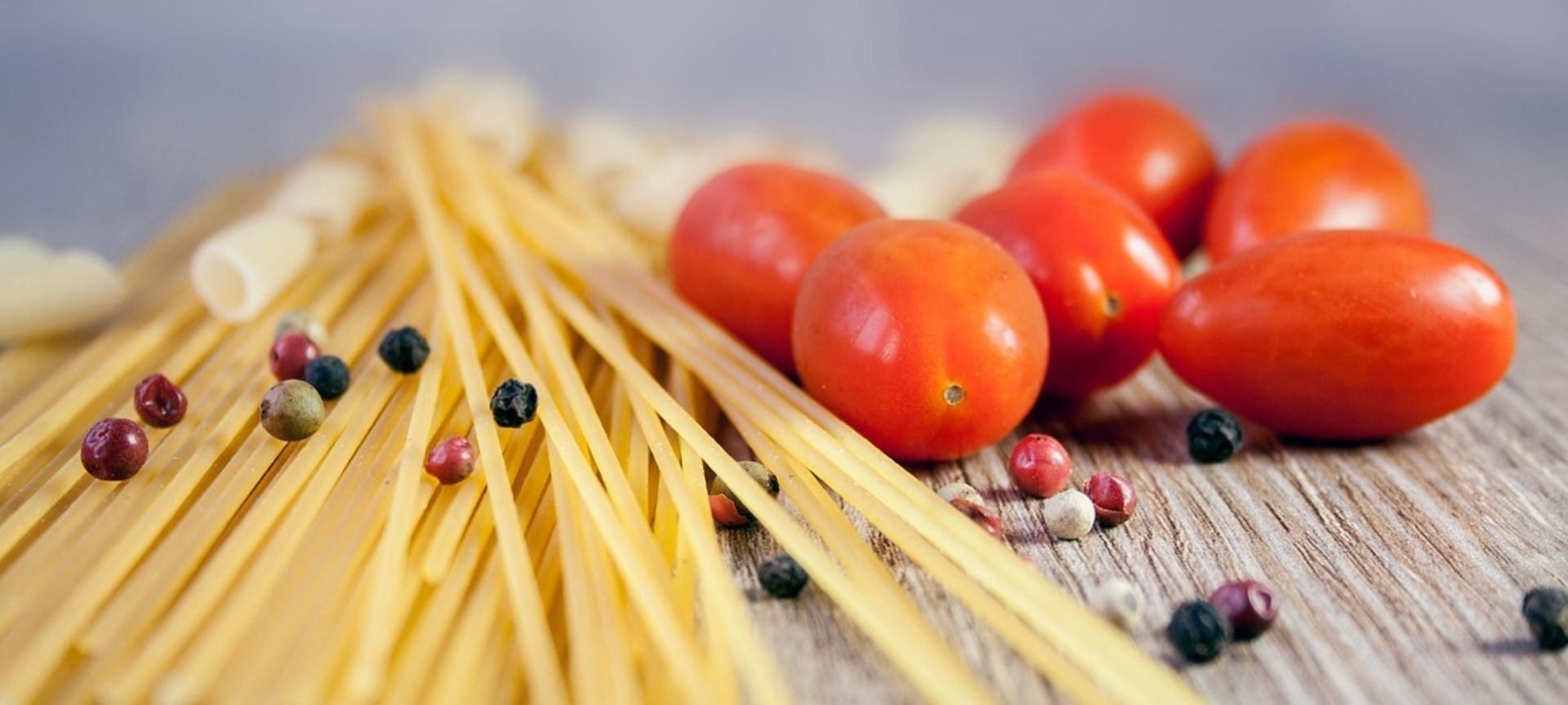 Pasta and tomatoes on kitchen worktop