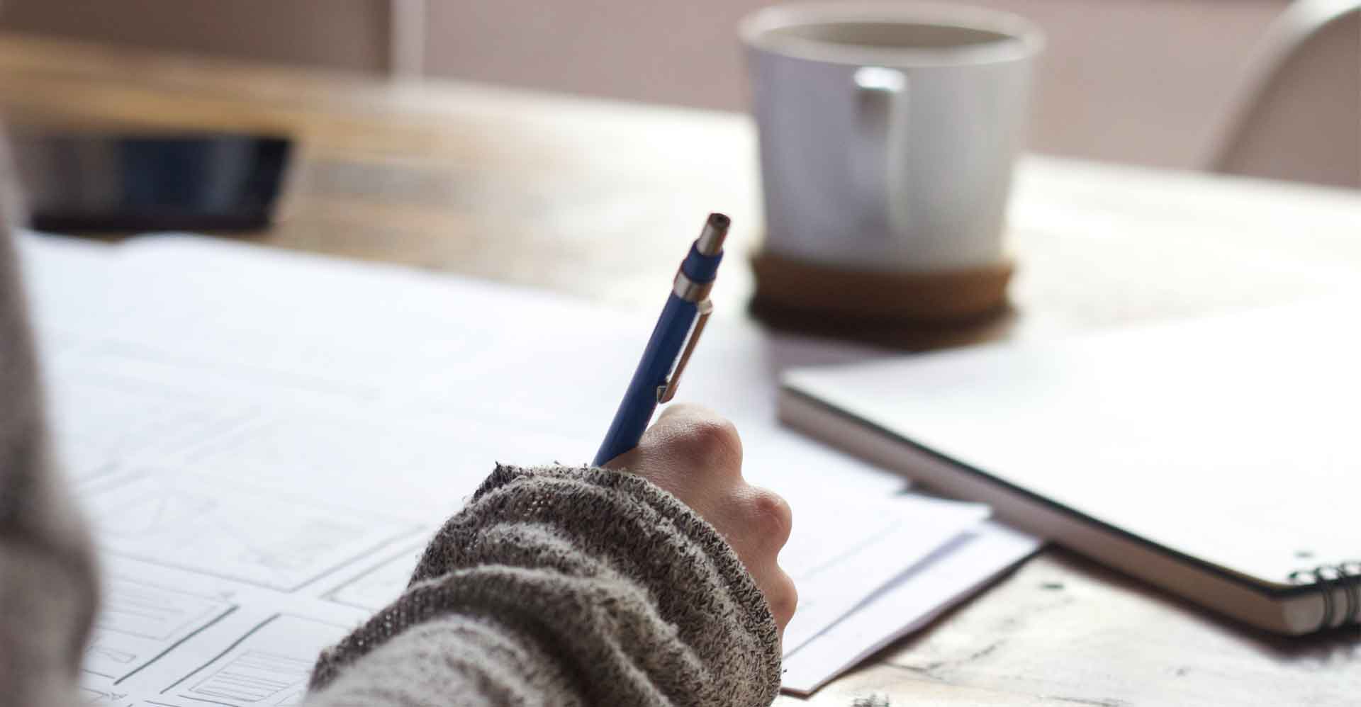 photo of lady making a list with pen and paper