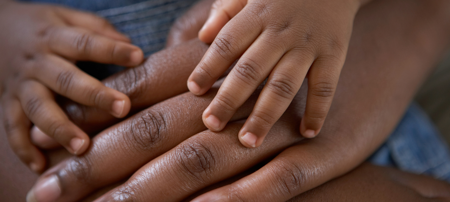 The hands of a mother and her child.