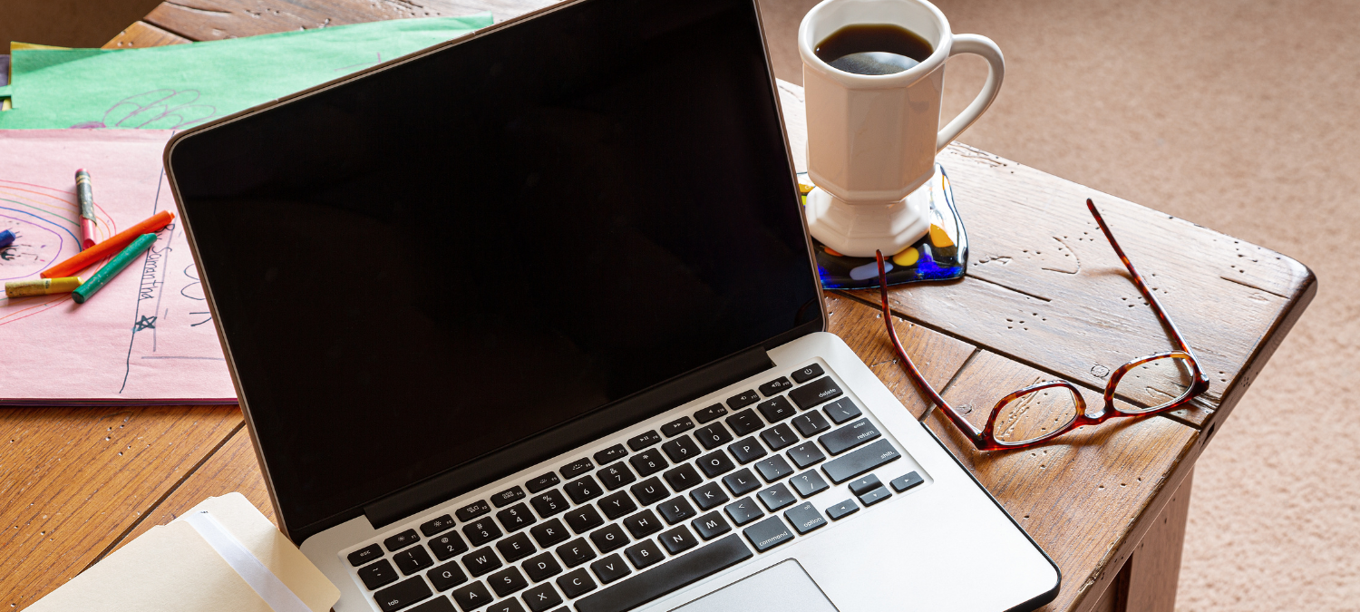 laptop, coffee and notes on a table