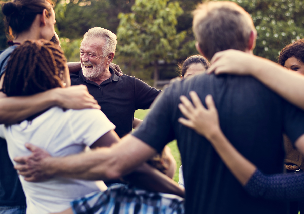 Photo of a group of people supporting each other.