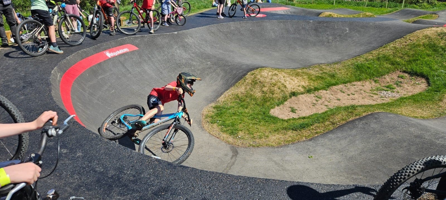 kid cycling on the new stow pump track