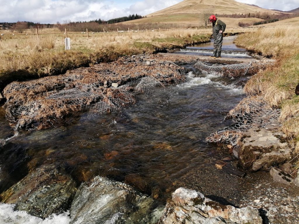 A man working in the river in wading gear