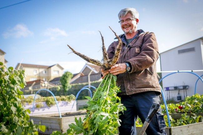 Photo of Baillie Gifford holding carrots.